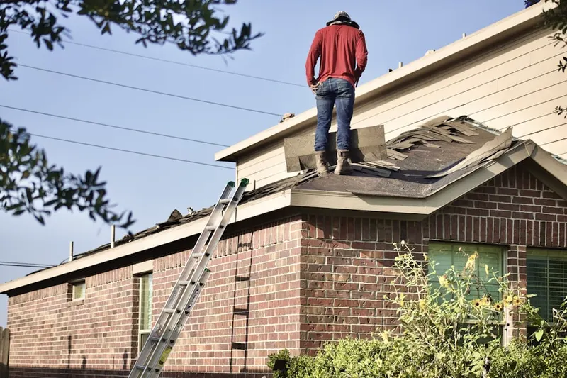 Professional roofer working on a residential roof in Paynesville